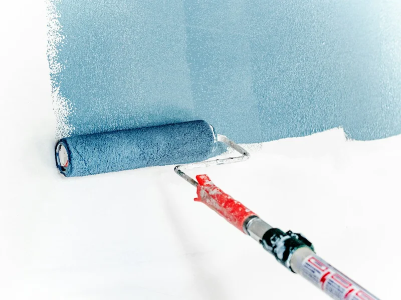 Professional painter tools, sealer pails, and edge masking tape on Singapore jobsite